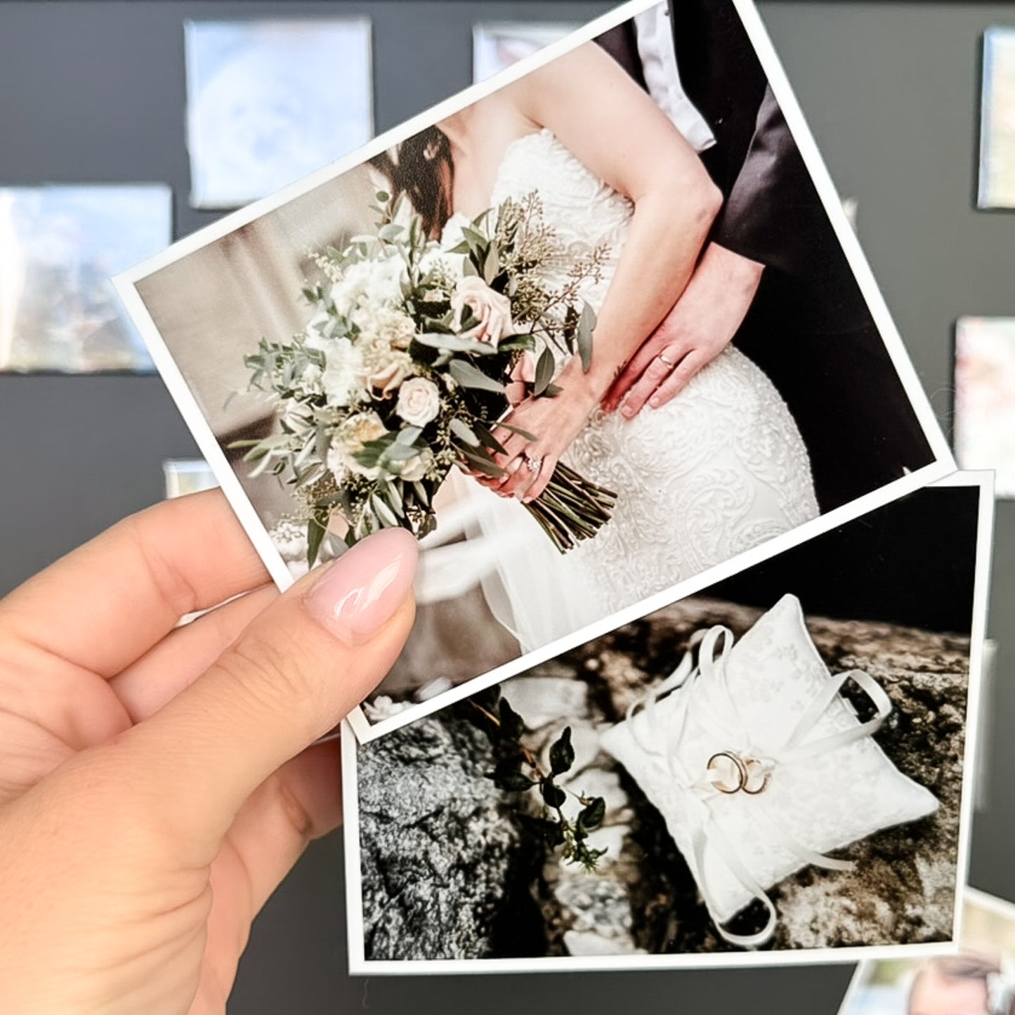 Hand holding a photo magnets of a wedding bouquet, rings, and a couple's hands.