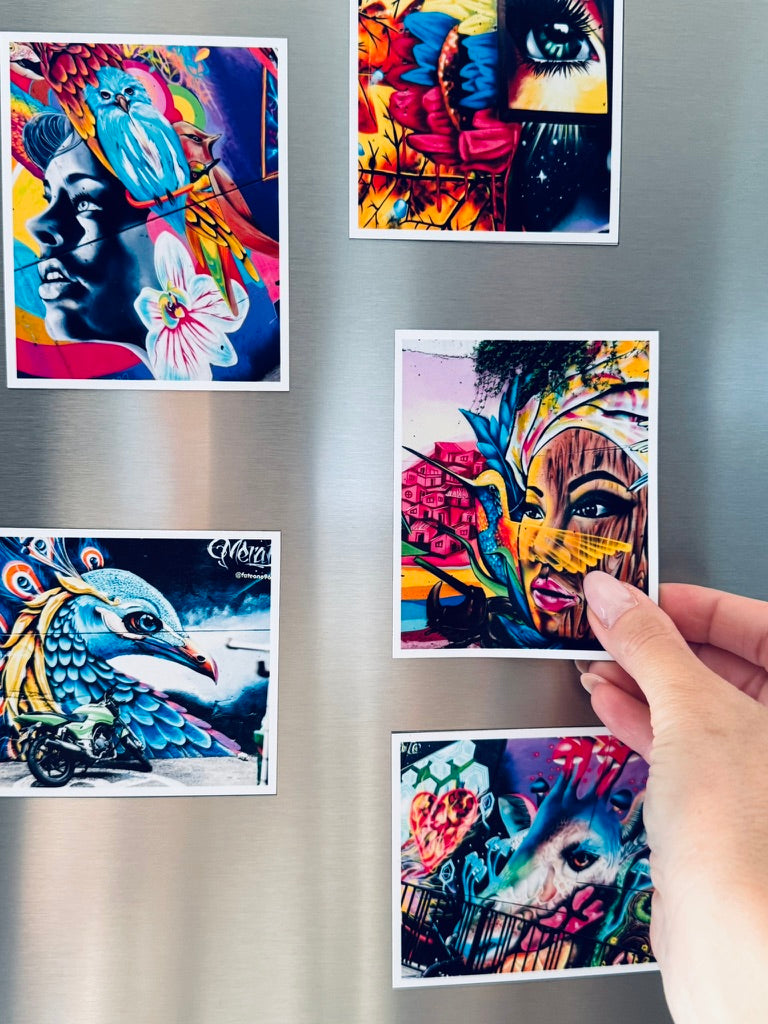 Colorful photo magnet of a woman's face, flowers, and a bird on a metallic surface.