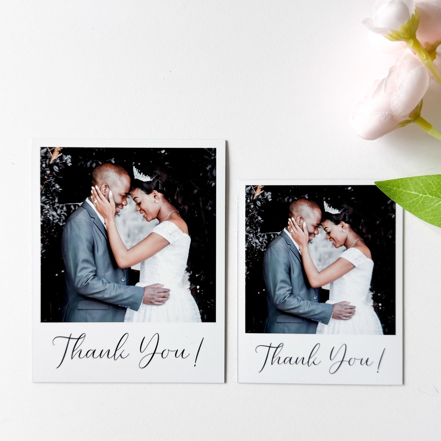 Two wedding photos magnets of a couple embracing with 'Thank You!' text, surrounded by flowers on a white background.