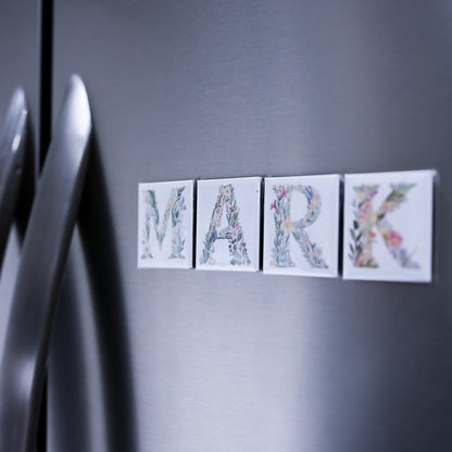 Decorative name magnets spelling 'MARK' on a refrigerator door.
