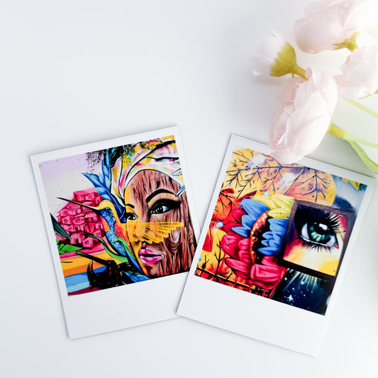 Two colorful art prints photo magnets of a woman's face and eye on a white surface with flowers.