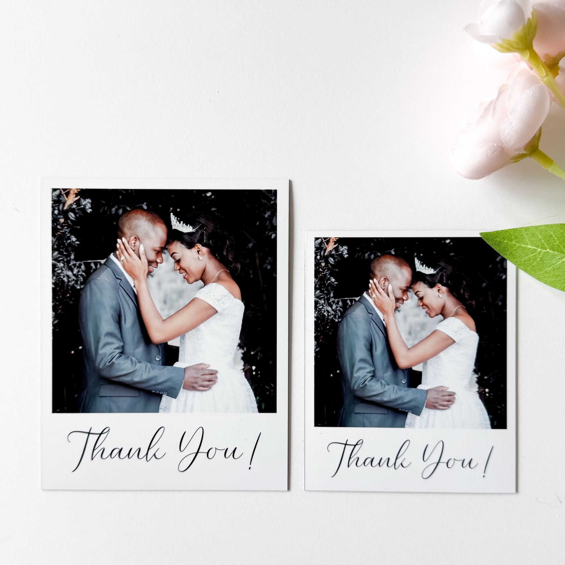 Two wedding photos magnets of a couple embracing with 'Thank You!' text, surrounded by flowers on a white background.